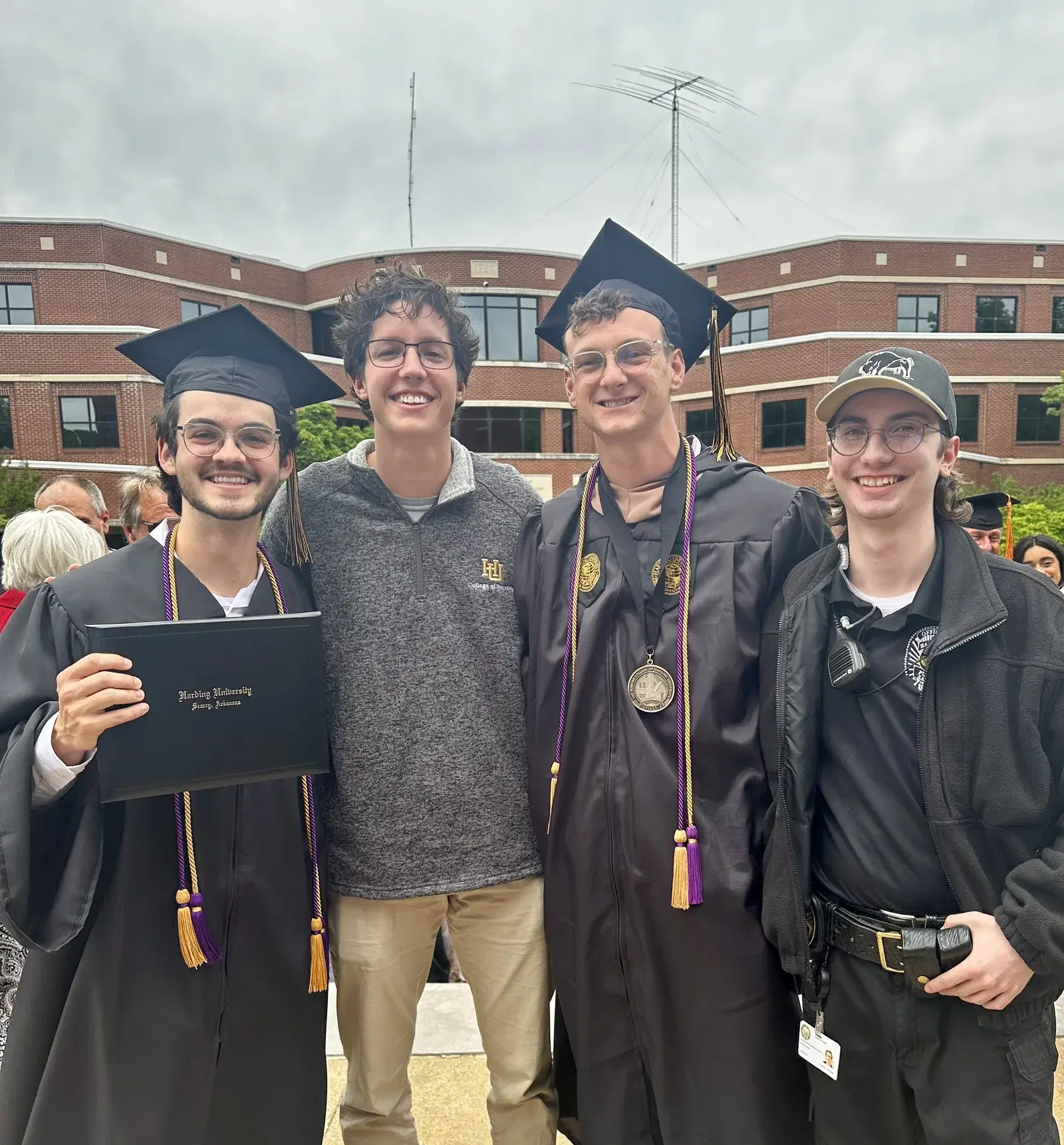 Aiden graduating from Harding University with his best friends